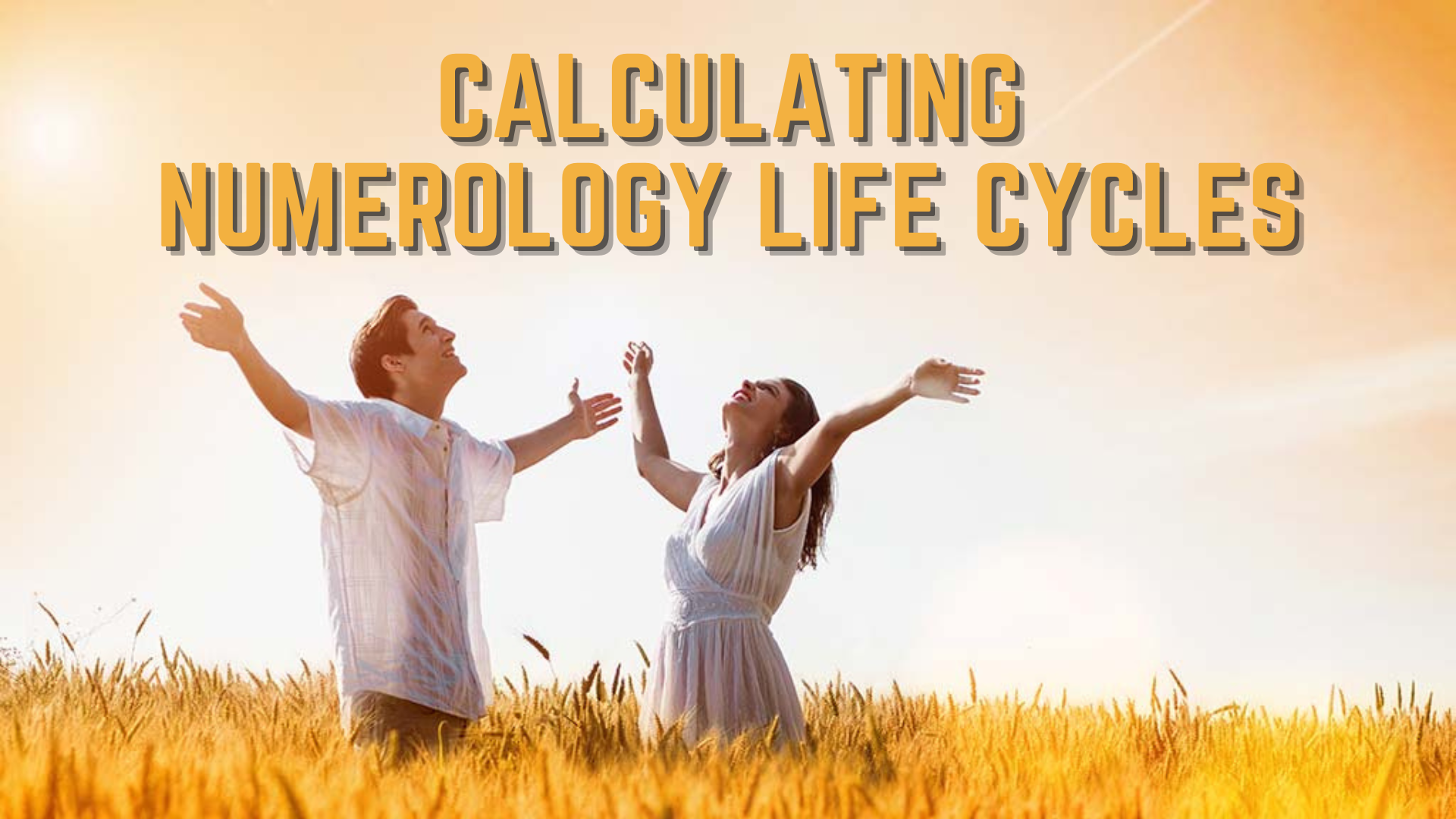 A man and woman looking at the sky while waising their hands standing in the field