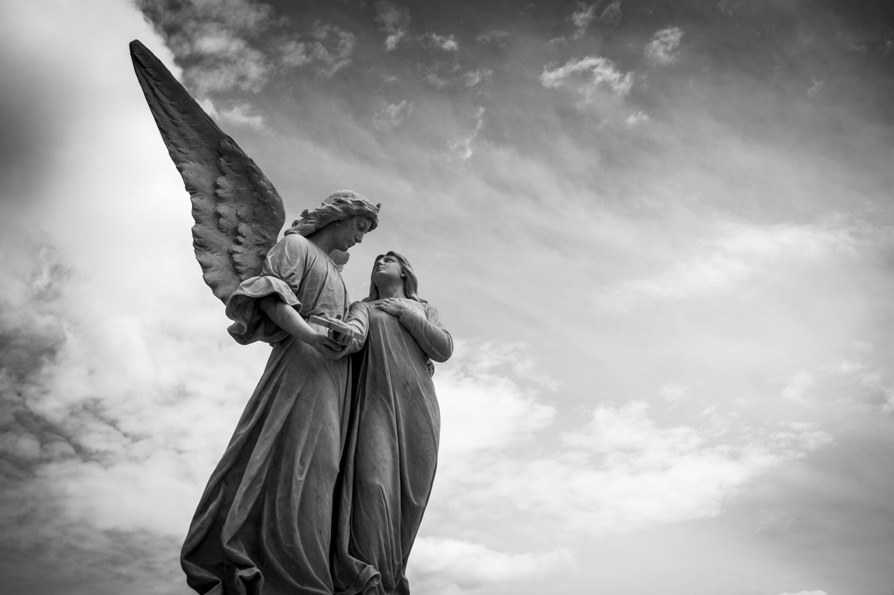 Angel Statue Under Cloudy Skies