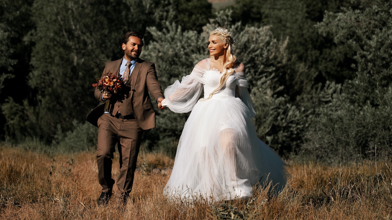 Bride and Groom Walking in Field
