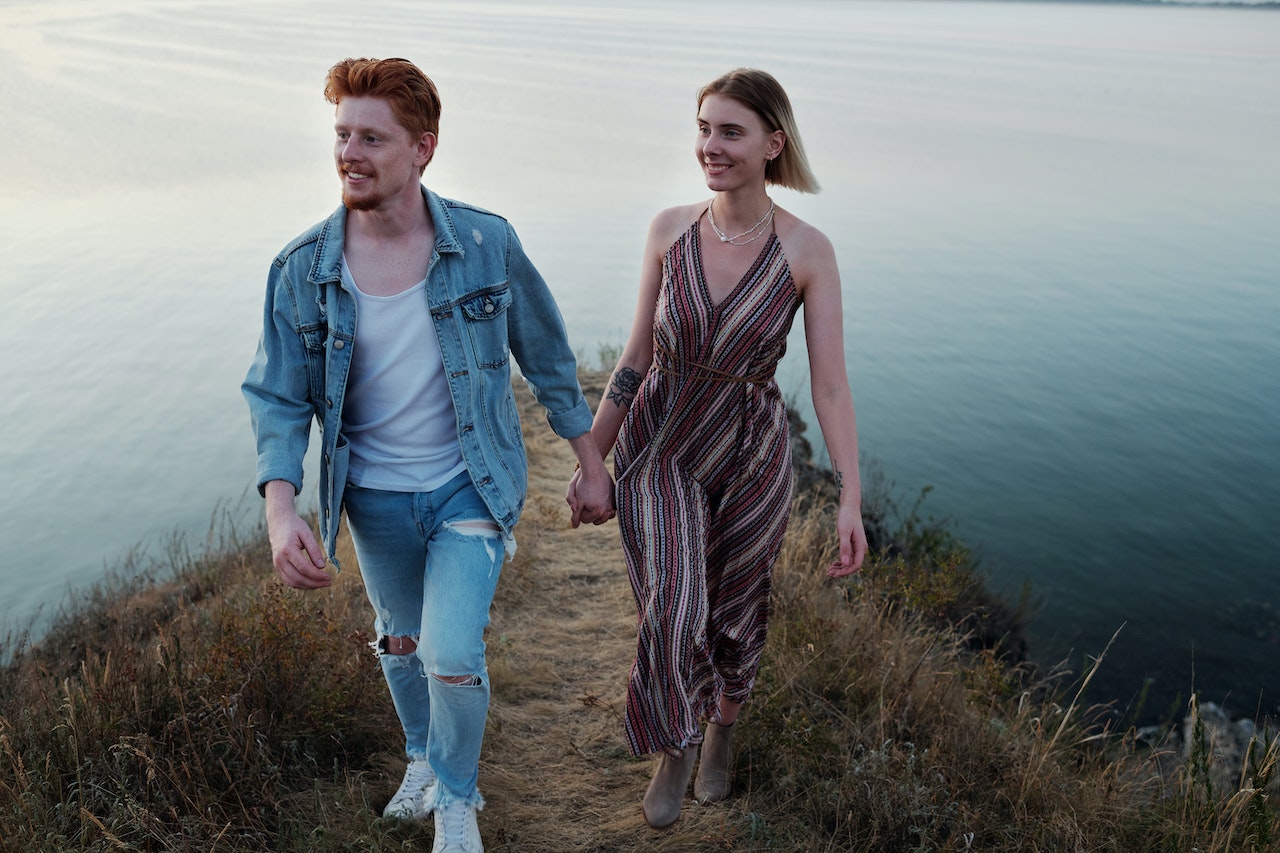 A Happy Couple Holding Hands while Walking