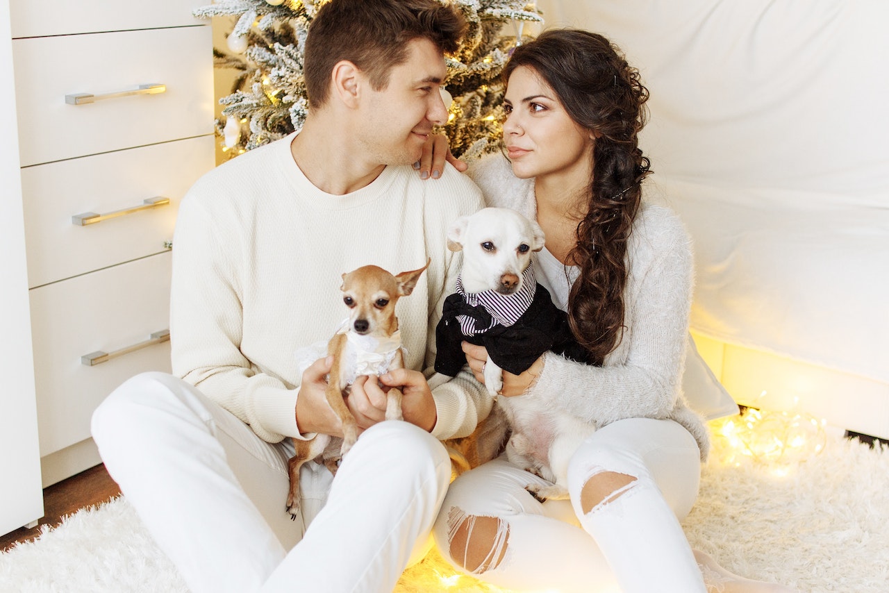 Happy Young Couple With Their Dogs