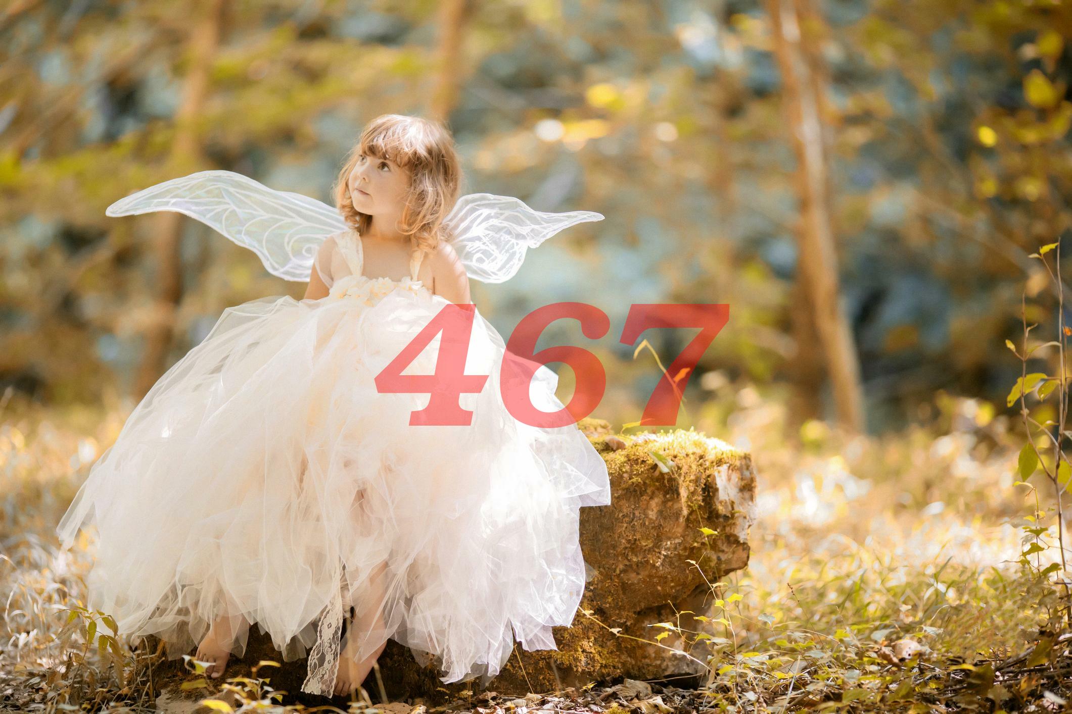 A little girl in white fairy costume with the 467 number.