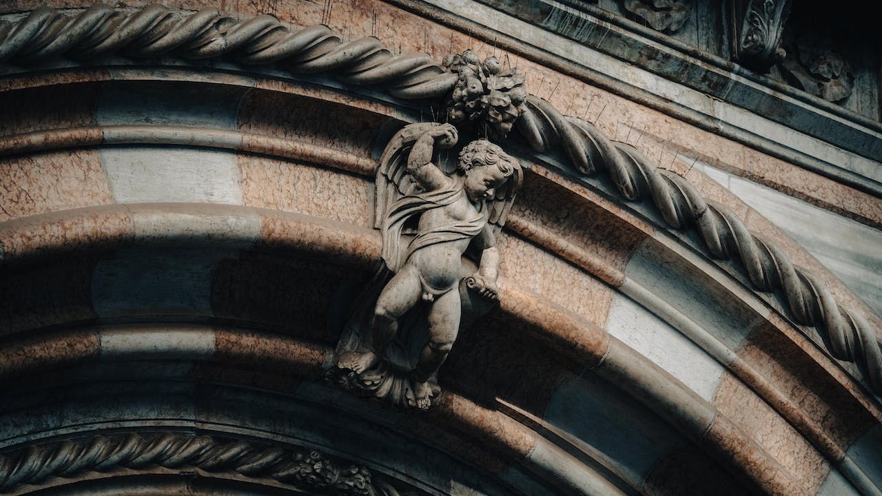 Ancient Angel Sculpture on Building Arch